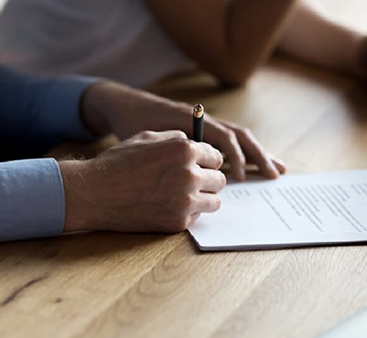 A man signing a contract